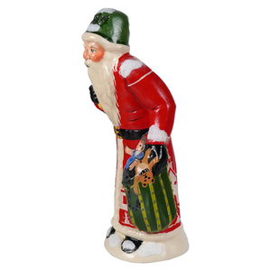 Hand-painted ceramic vaillancourt folk art santa in red coat green hat holding striped festive sack from 40th anniversary 2024
