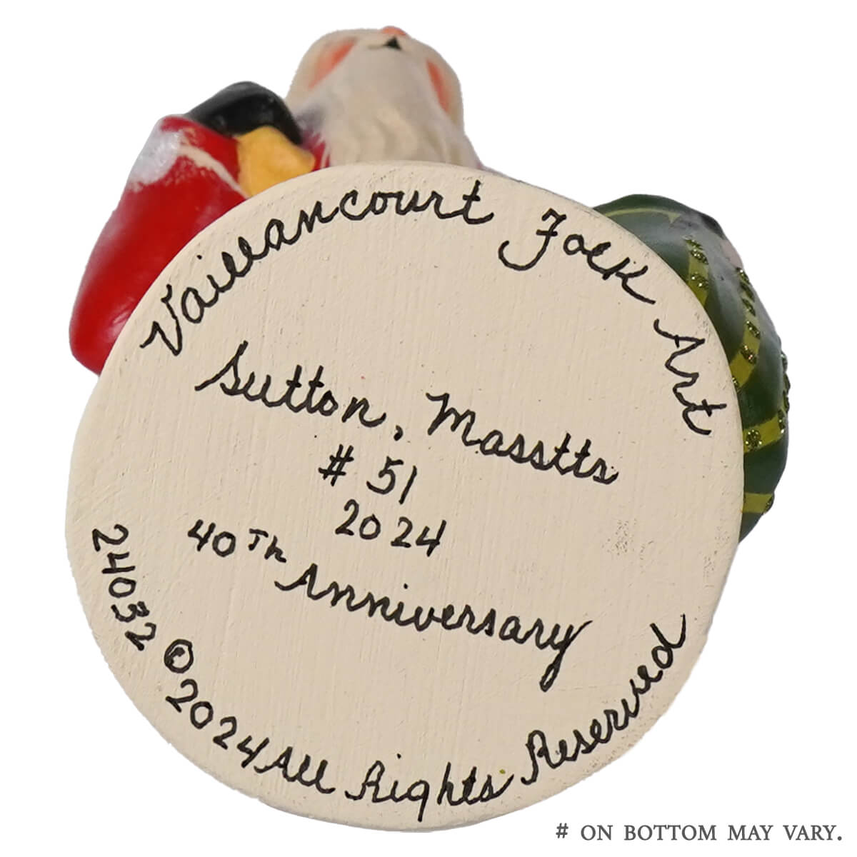 Hand-painted ceramic santa with red and yellow trim green hat and white beard from vaillancourt folk art 40th anniversary