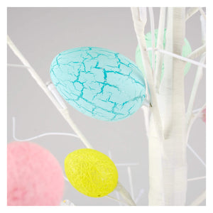 A turquoise cracked glossy egg hanging on white branches of a 47 inch large lighted easter egg tree