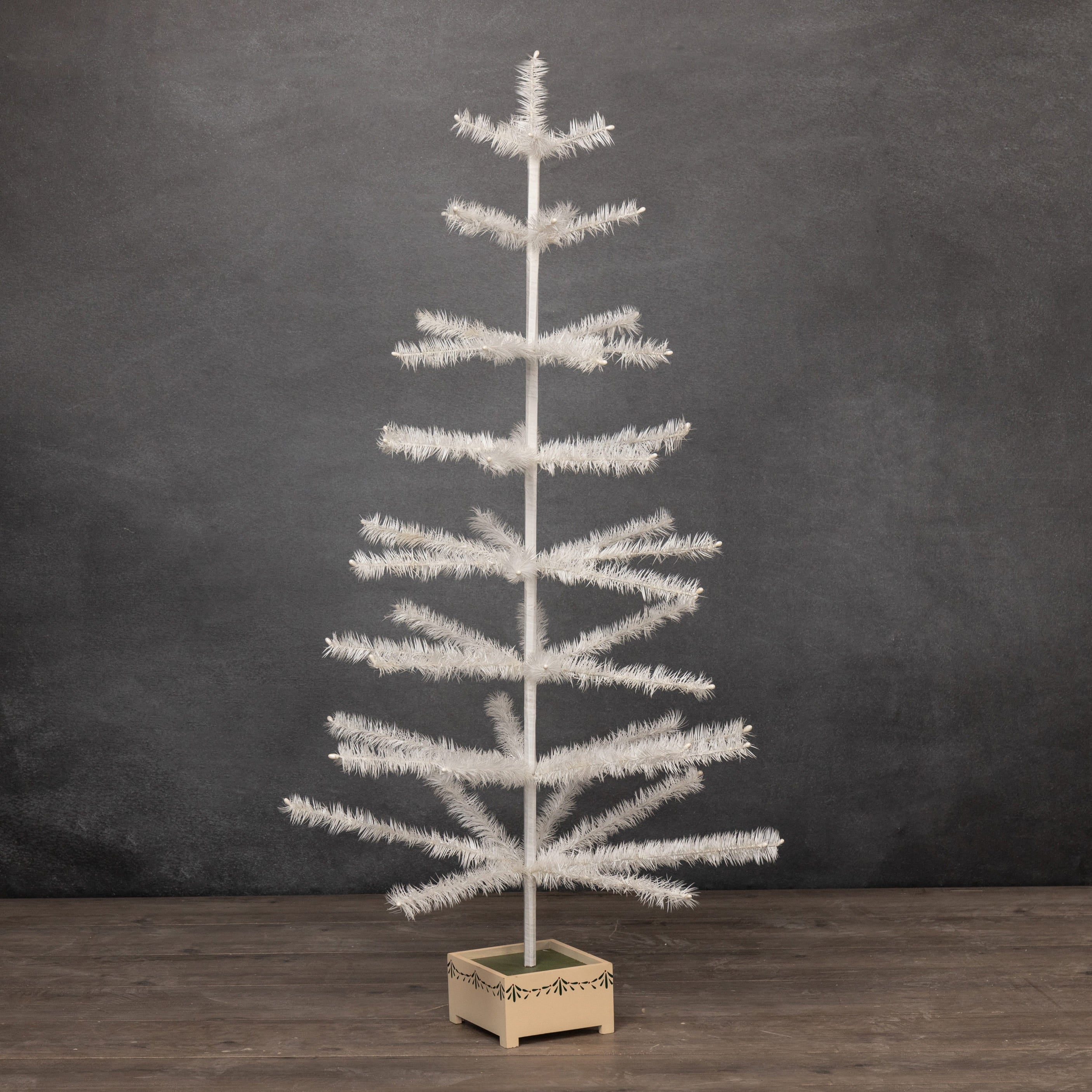 48 inch ivory feather tree with wood base featuring a slender tiered design and frosted branch tips perfect as a tinsel tree