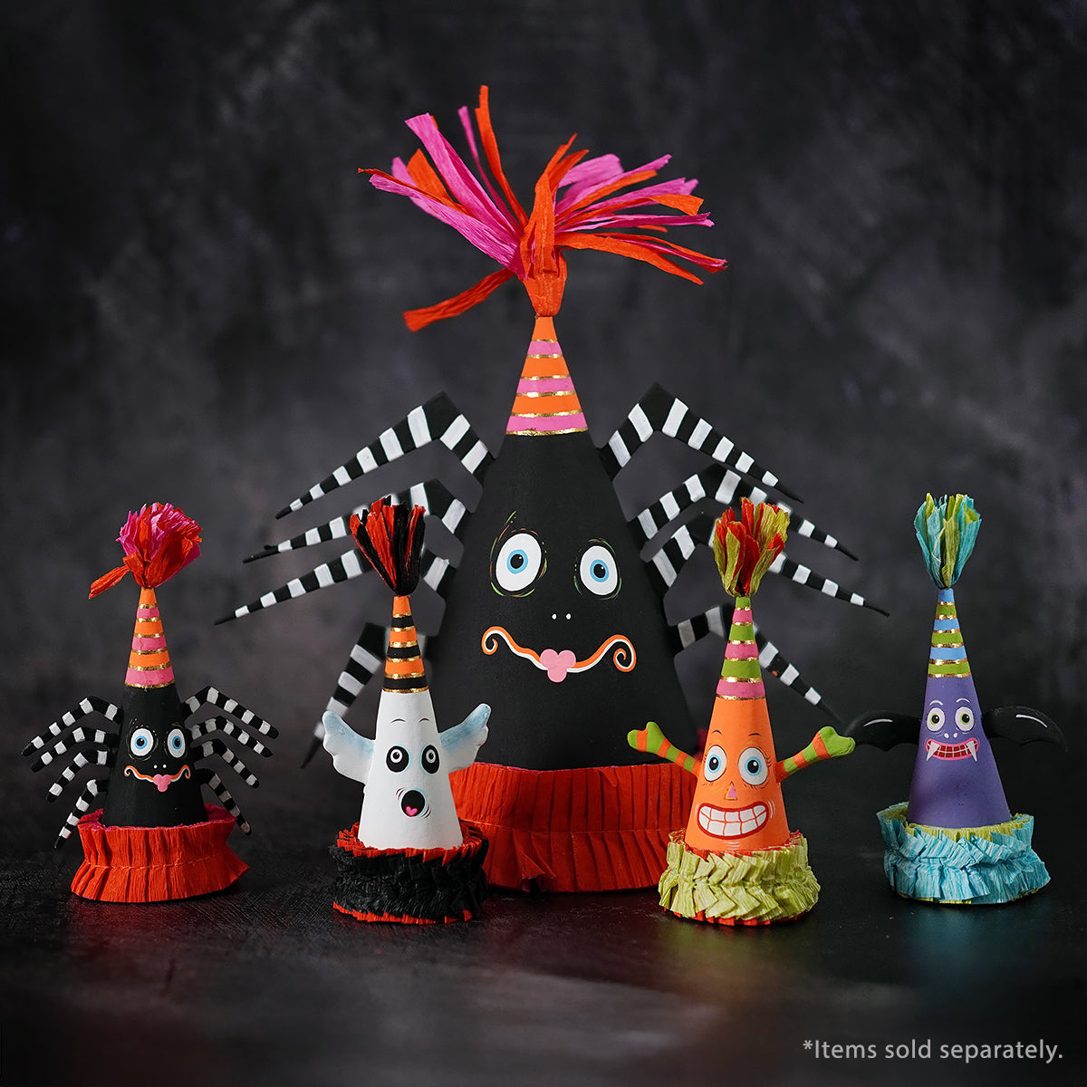 A whimsical black spider mini cone party hat with striped legs blue eyes pink mustache and orange pink tassel perfect halloween ghost figures decor ornaments