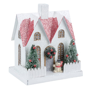 Lighted fenced house sitter figurine with glittery pink roof frosted green trees and snowman in front