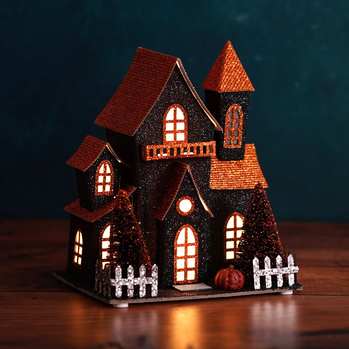 7.5 inch led lighted black glittery halloween haunted house with orange glitter roofs and white picket fence by regency international