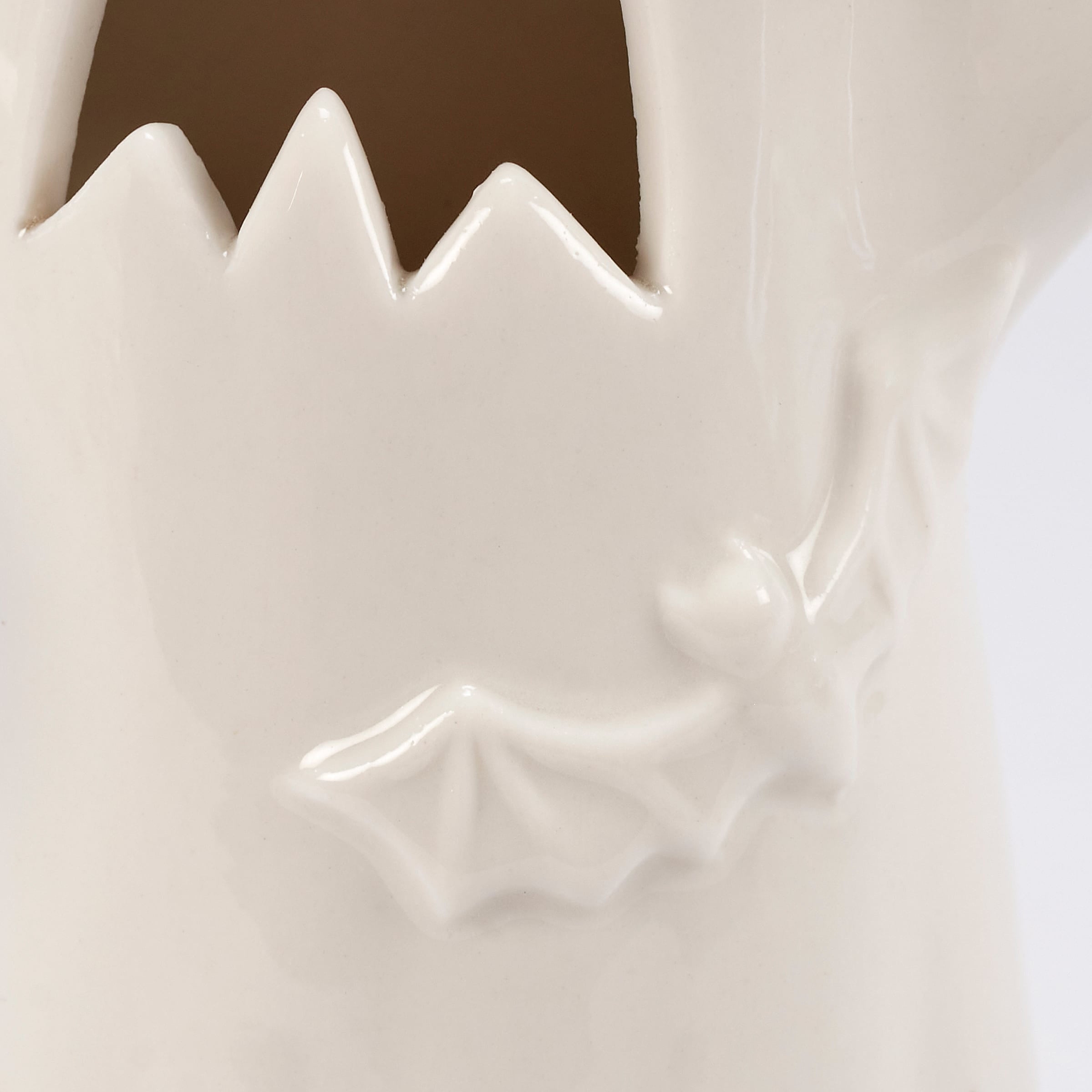 White ceramic lighted ghost figurine with jagged tooth-like opening and embossed bat design for halloween ghost figures