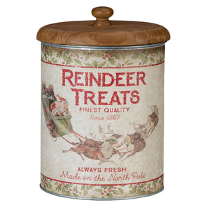 Vintage-style metal reindeer treats canister with wooden lid and festive santa and reindeer artwork on cream surface