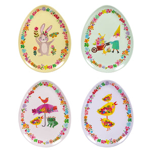 Four egg-shaped plates decorated with whimsical spring designs featuring bunnies, birds, gnomes, and floral borders.