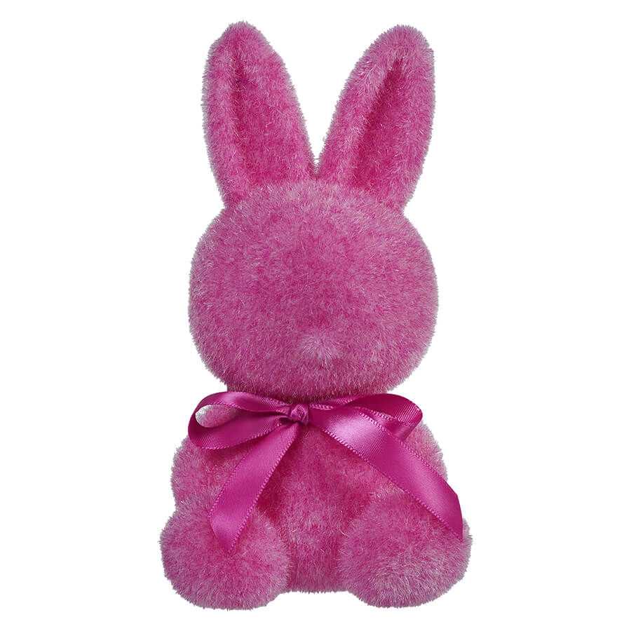 Pink plush bunny with a satin bow around its neck.