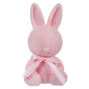Pink plush bunny with a ribbon bow around its neck.