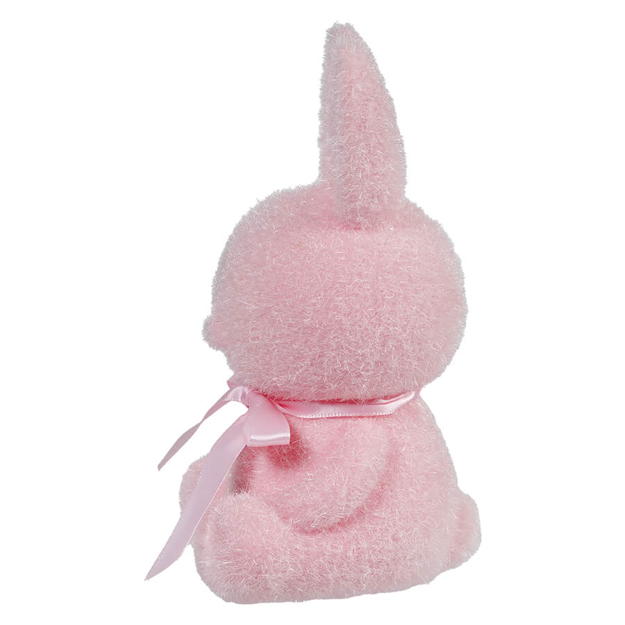 Pink plush bunny with a bow ribbon around its neck.