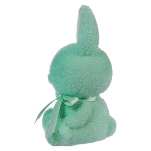 Mint green plush bunny with a ribbon bow tied around its neck.