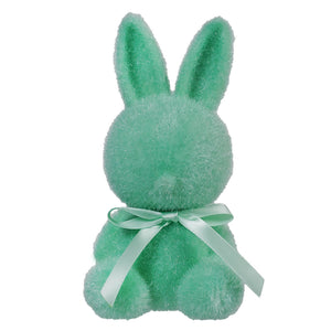 Mint green plush bunny with a light bow around its neck.
