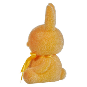 Yellow plush bunny with a ribbon bow around its neck.