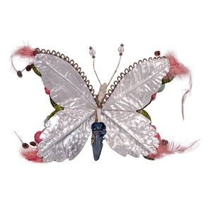 A 7 inch floral beaded butterfly clip with iridescent white wings pink feathers and glittered pastel clip-on design