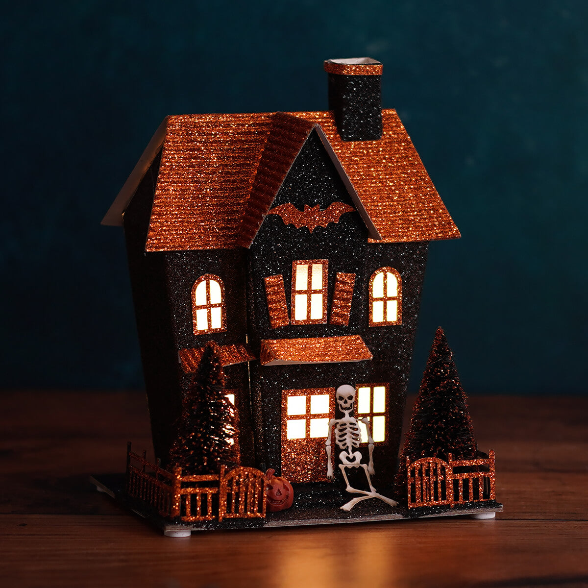 8.25 inch led lighted black and orange halloween haunted house with skeleton figure and miniature trees by regency international