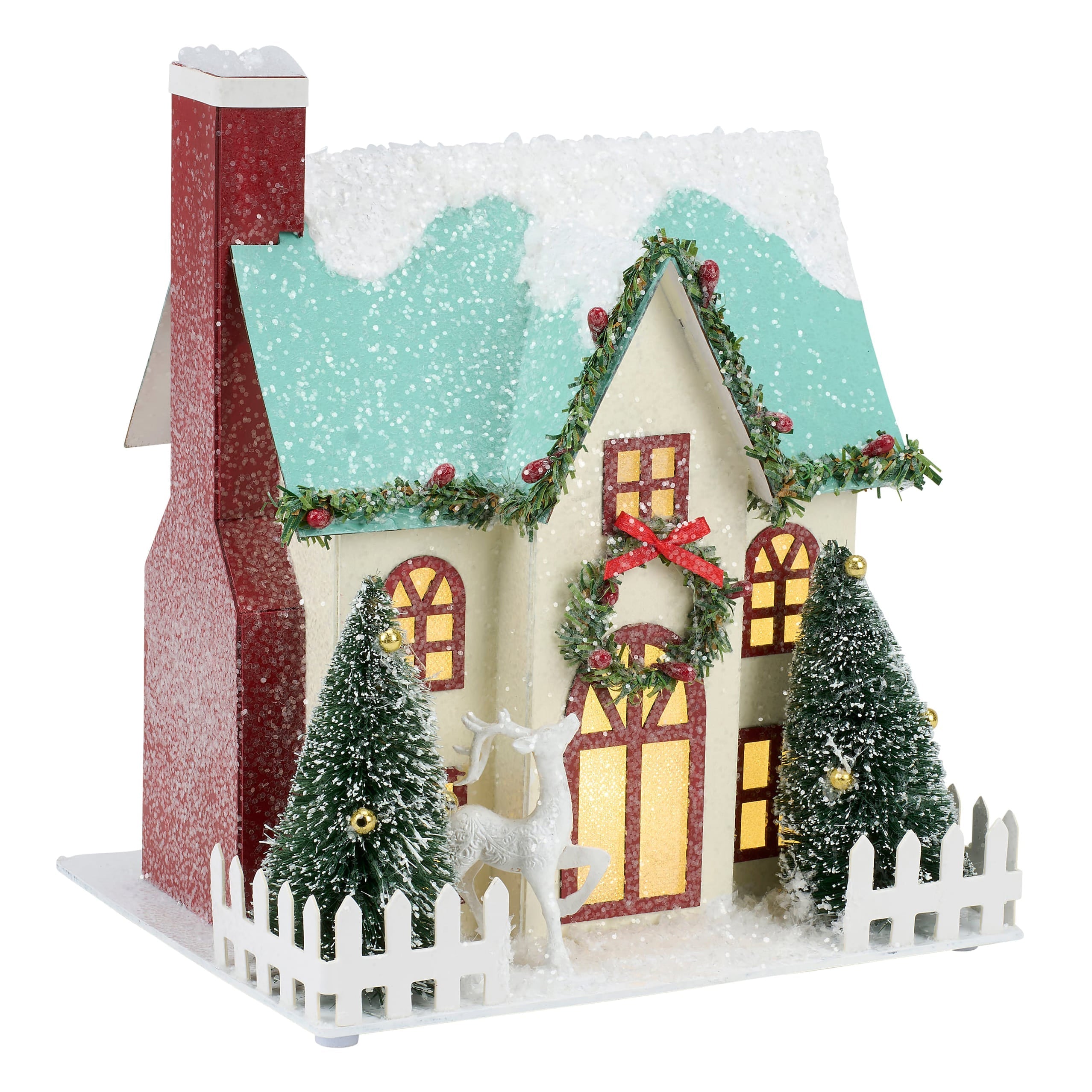 A festive lighted wreath house sitter with cream walls, teal roof, glittery red chimney, green garlands, and red bows