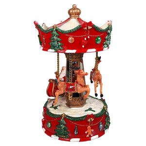 Red and gold santa’s sleigh carousel music box by raz imports with festive decorations and miniature reindeer figures from north pole