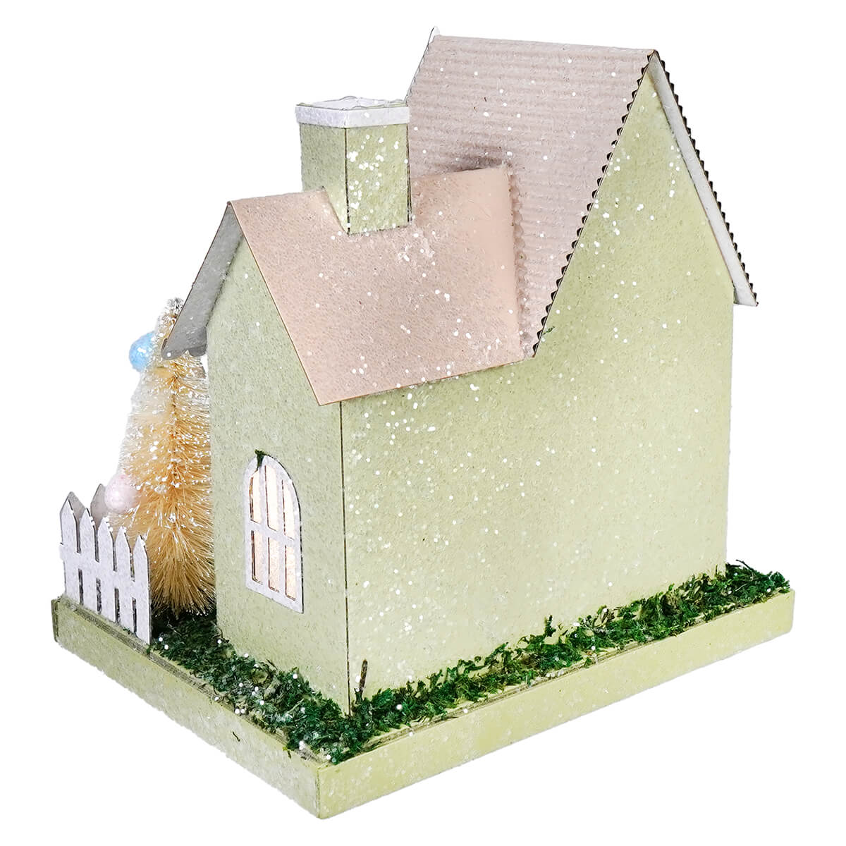 A glittery pastel green lighted led bunny easter house with pink roof white picket fence and faux grass base