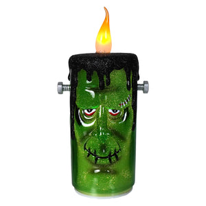 9.25 inch green glittery flickering frankenstein candle with black wax drips and silver bolts perfect for halloween candles