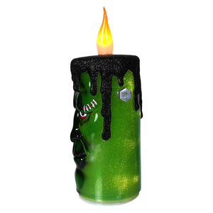 Green glittery frankenstein flickering candle with black wax drips and glowing orange flame perfect halloween candles decor