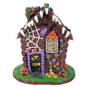 A 9.5 inch lighted halloween gingerbread house decoration with bright halloween lights and decor for spooky village display
