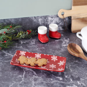 Red rectangular ceramic snowflake platter holding gingerbread cookies perfect for holiday serving