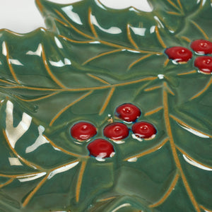 Green ceramic holly berry tree plate shaped like a holly leaf with glossy red berries and gold leaf veining