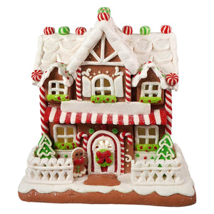 9 inch led lighted two floor gingerbread junction house with red and white candy cane accents and figural decor trees