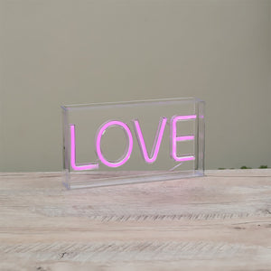 Pink neon ’LOVE’ text enclosed in a clear acrylic box.