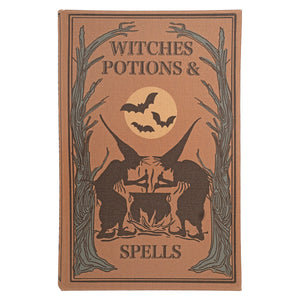 A vintage-style hardcover book titled "Witches Potions & Spells" with a tan cover, dark brown illustration of two figures around cauldrons under a full moon with bats, and gray tree silhouettes.
