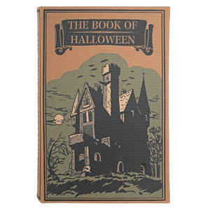 Vintage-style book cover titled "The Book of Halloween" featuring an illustration of a haunted house, bats, trees, and a full moon on a tan background.