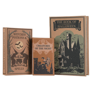 Three decorative hardcover books (boxes) with vintage Halloween-themed covers: 'Witches Potions & Spells', 'Creatures of the Night', and 'The Book of Halloween', arranged against a plain white background.