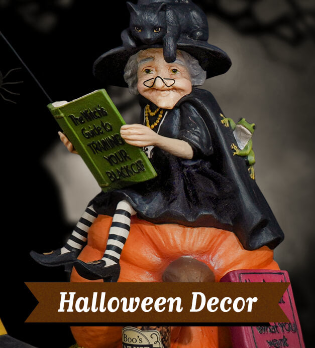 A Halloween figurine of an elderly witch sitting on a pumpkin, with the text "Halloween Decor".