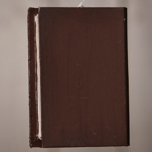 Dark brown bethany lowe witches & witch decor book ornament with textured matte finish and visible spine details