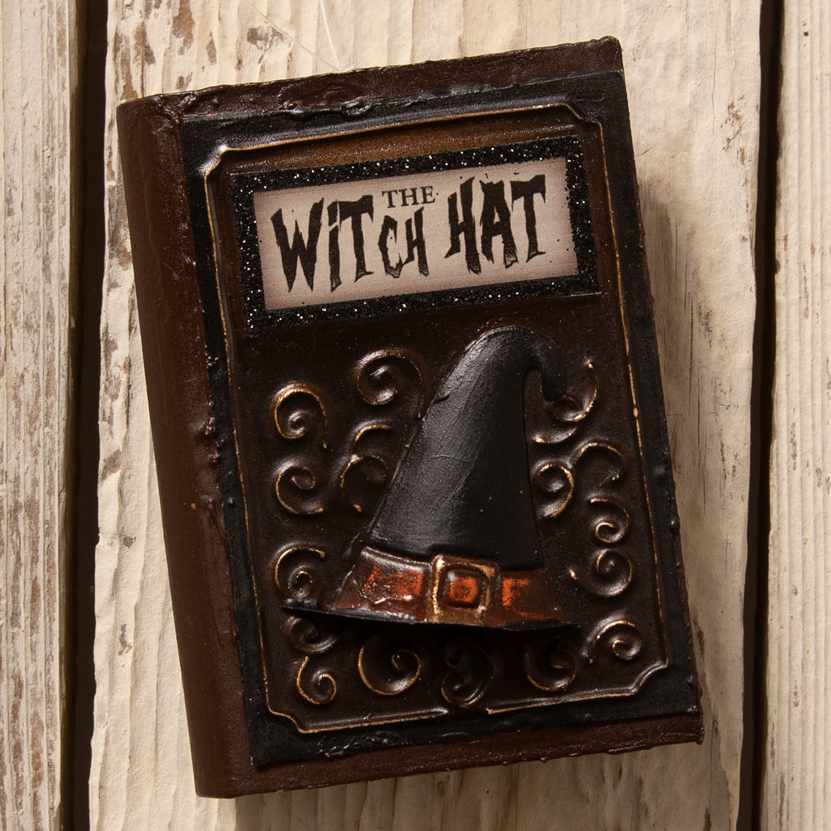 Dark brown ornate book ornament with black witch hat and orange belt perfect for bethany lowe witches decor