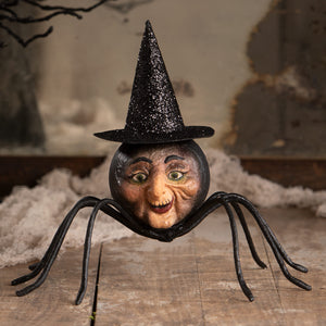 A whimsical black spider figurine with a painted face and glittery witch hat perfect for halloween witches decor