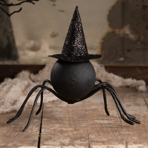 Black glittery witch hat on a matte black spider with wire legs perfect for halloween witches and witch decor