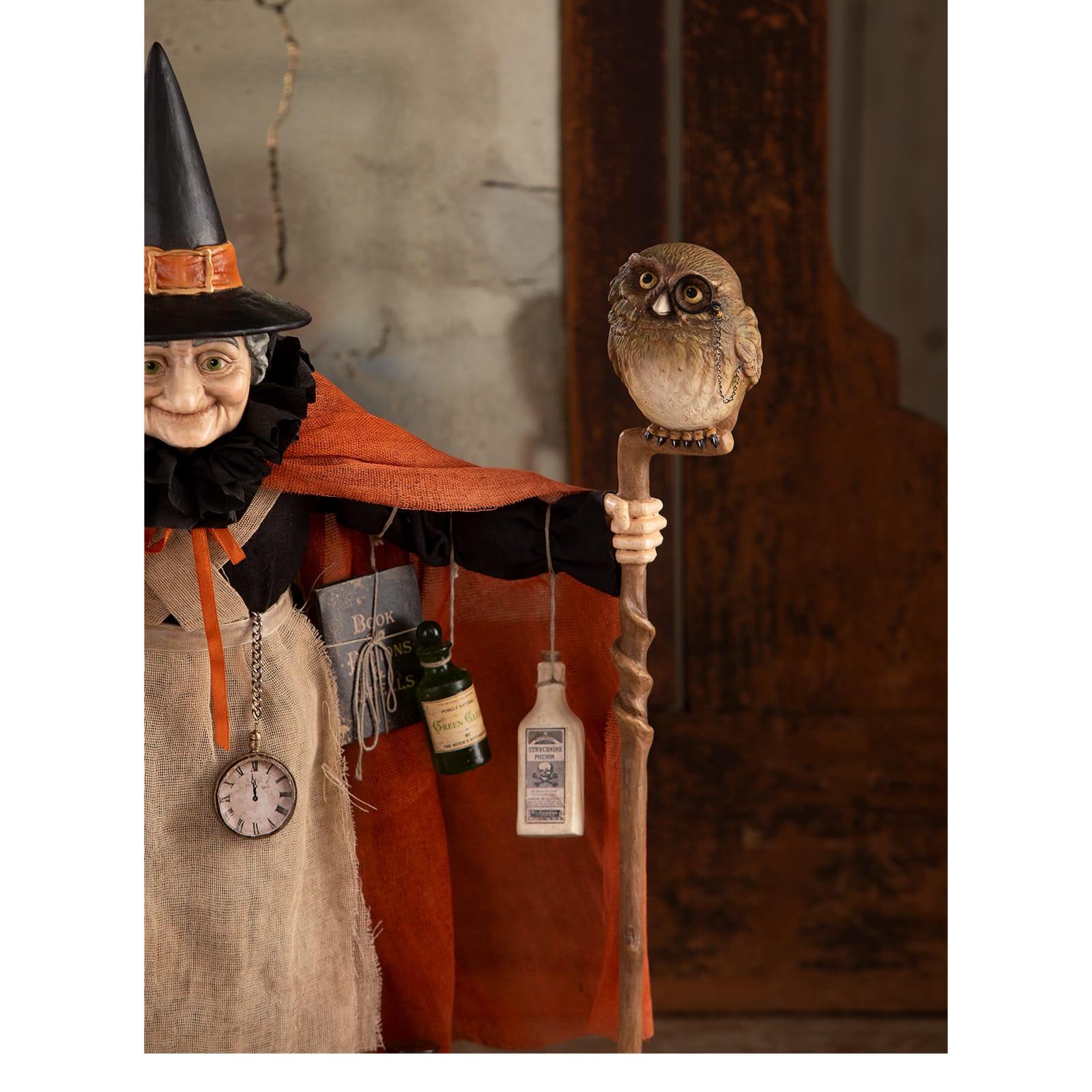 A lifelike owl perched on a twisted wooden staff witch decor perfect for halloween witches and zelda witch fans