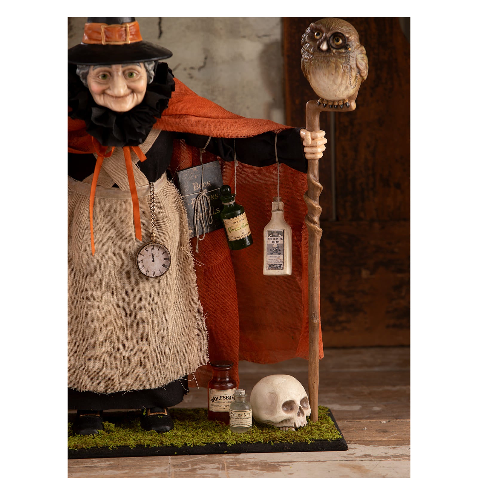Potion peddler zelda witch figurine wearing black hat with orange band and burlap apron holding wooden staff with carved owl perfect for halloween witches and witch decor