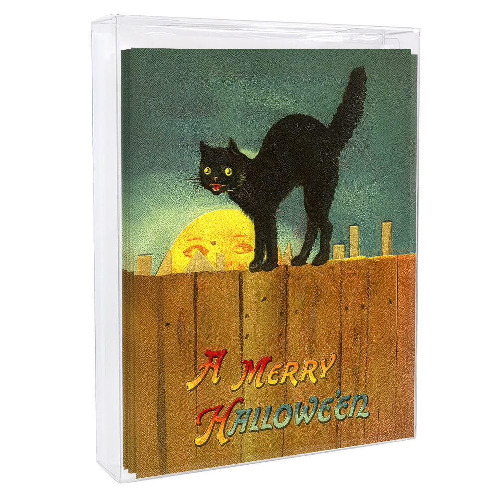 A black cat greeting card features a glowing yellow eyed cat on a wooden fence with a crescent moon in a teal sky
