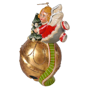 A festive angel ornament with golden wings red dress holding miniature christmas tree on gold green bauble vaillancourt folk art