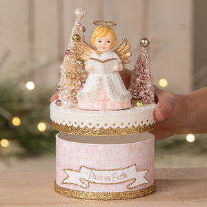 Delicate bethany lowe angel figure with golden wings stands on pearl decorated christmas trees on glittery music box