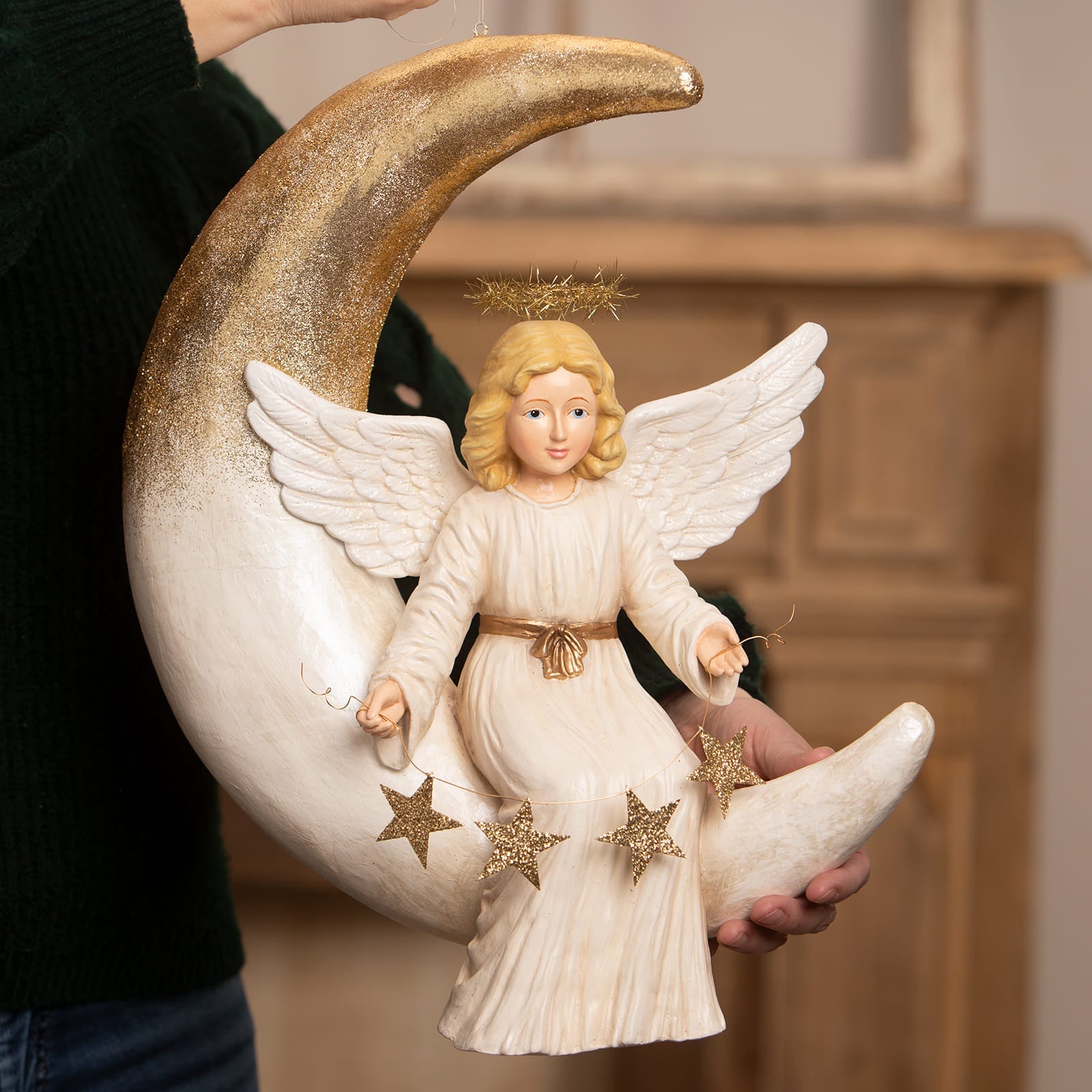 Angelica on moon bethany lowe design angel figure with blonde hair cream gown and gold accents on glitter crescent moon