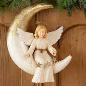 A white angelica on moon figurine with gold glitter wings seated on a star-decorated crescent moon by bethany lowe design