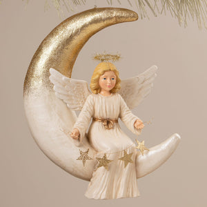 Angelica on moon bethany lowe design angel figure with blonde hair cream robe gold trim on glittering crescent moon decor