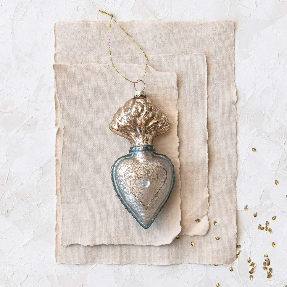 Vintage-style glass Christmas ornament shaped like a heart with a decorative top.