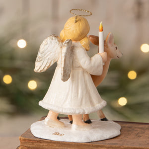 White angel figurine with gold halo and silver wings holding candle next to deer bethany lowe angel figures decor