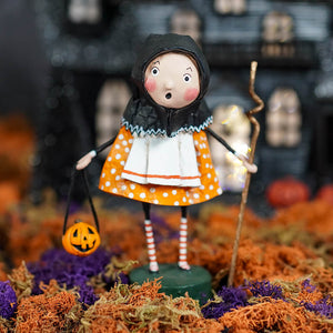 Whimsical halloween witch figurine baba yoga with black hooded cloak orange polka-dot dress and striped stockings