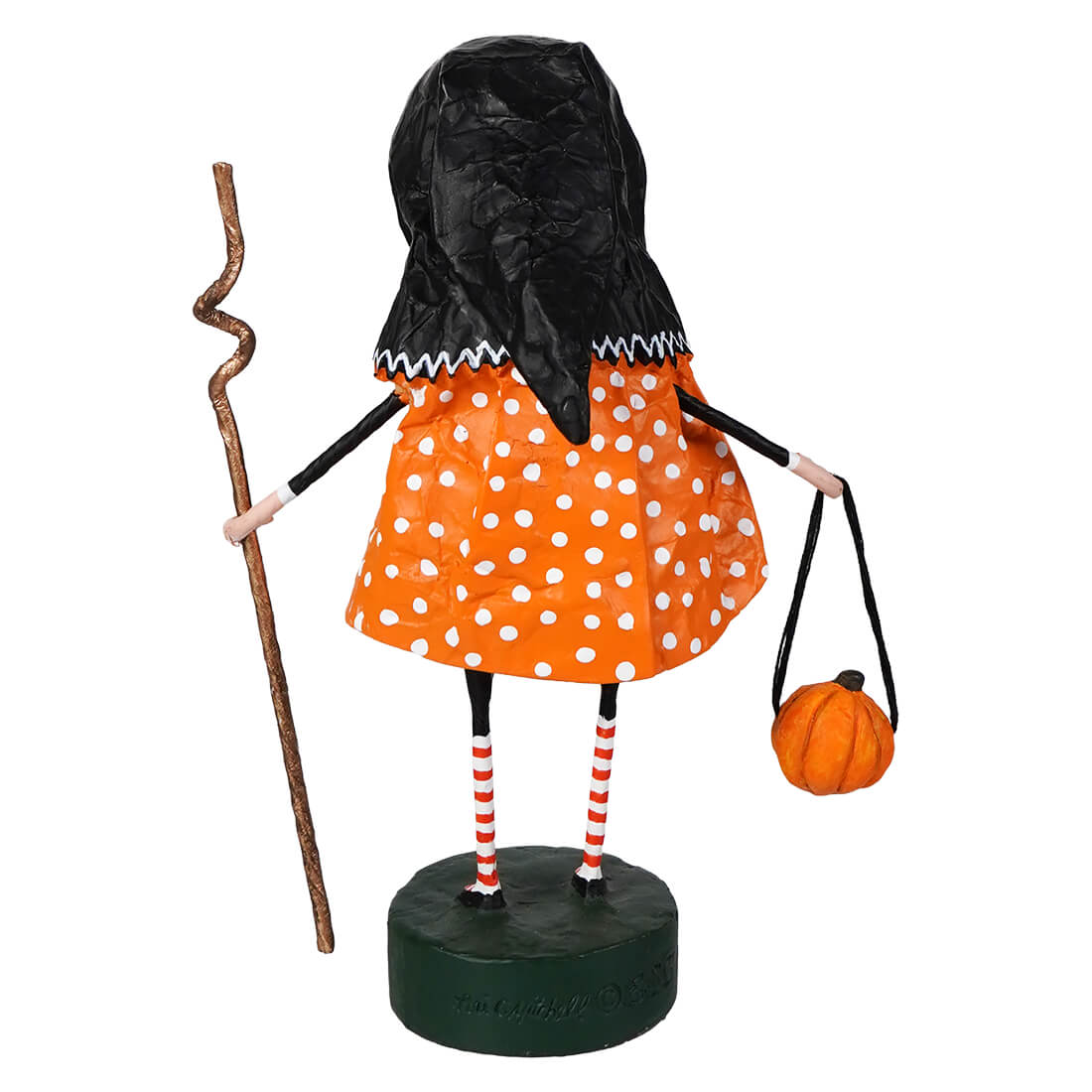 Orange polka-dot baba yaga witch figurine with black hood and striped legs on green base lori mitchell halloween figure