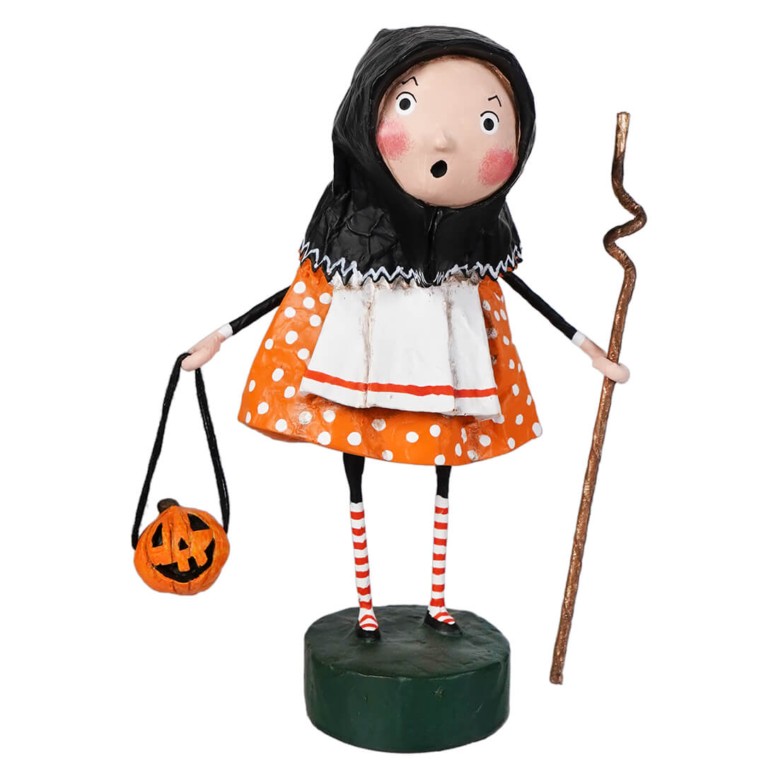 Orange polka dot halloween witch figurine with black hood and striped socks on green base from lori mitchell halloween baba yaga collection