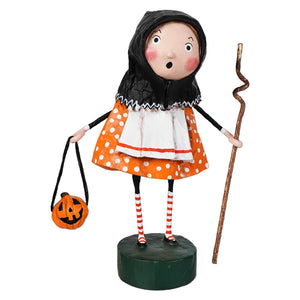 Orange polka dot halloween witch figurine with black hood and striped socks on green base from lori mitchell halloween baba yaga collection